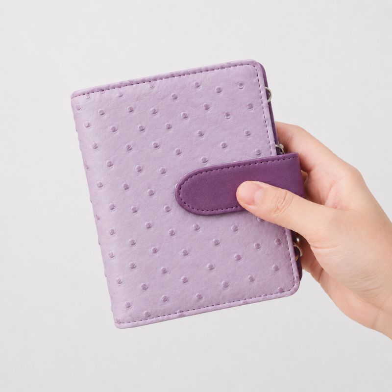 Closed lilac ostrich-texture Nomad kit with an inset 